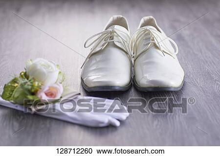 Stock Image - White Shoes With Globes And Flowers. Fotosearch