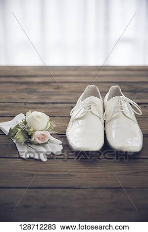 Stock Image - White Shoes With Globes And Flowers. Fotosearch