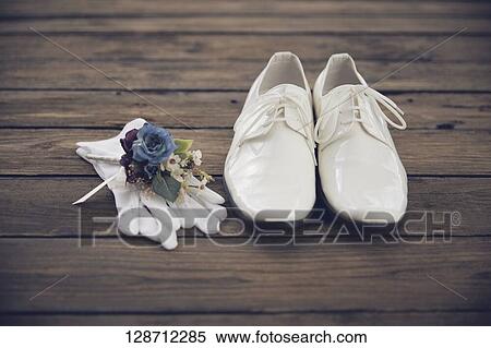 Stock Photography - White Shoes With Globes And Flowers. Fotosearch