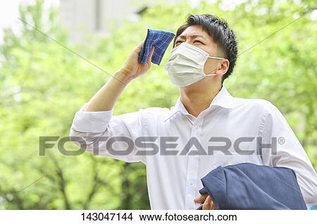 Young Japanese businessman wearing mask in the hot Summer downtown Tokyo View Large Photo Image Picture - Young Japanese businessman wearing mask in the hot Summer downtown Tokyo. Fotosearch