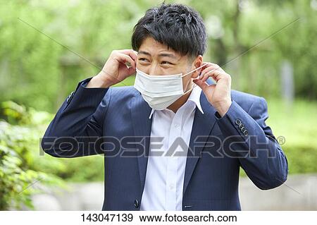 Young Japanese businessman wearing mask in the hot Summer downtown Tokyo View Large Photo Image Stock Photo - Young Japanese businessman wearing mask in the hot Summer downtown Tokyo. Fotosearch