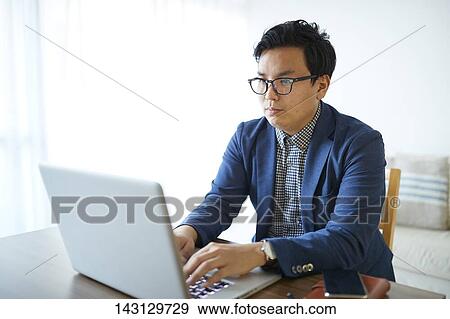 Young Japanese businessman working with laptop View Large Photo Image Stock Photo - Young Japanese businessman working with laptop. Fotosearch