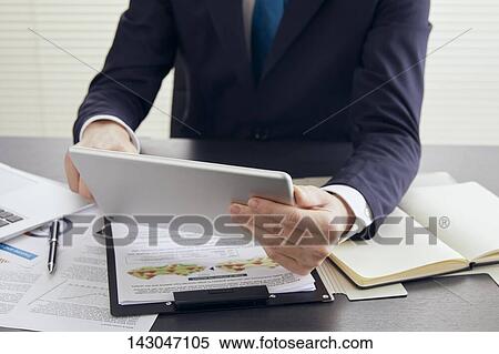 Young Japanese businessman working with tablet View Large Photo Image Stock Photography - Young Japanese businessman working with tablet. Fotosearch