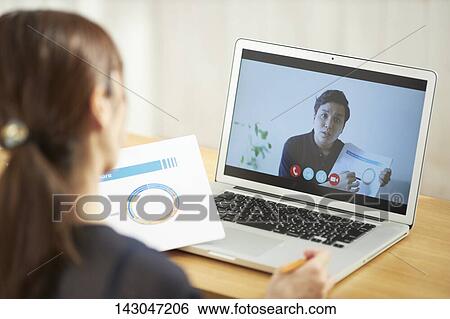 Young Japanese businesswoman having remote meeting at home View Large Photo Image Stock Photograph - Young Japanese businesswoman having remote meeting at home. Fotosearch