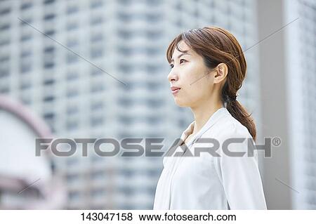 Young Japanese businesswoman in the hot Summer downtown Tokyo View Large Photo Image Stock Photo - Young Japanese businesswoman in the hot Summer downtown Tokyo. Fotosearch