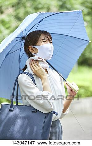 Young Japanese businesswoman wearing mask in the hot Summer downtown Tokyo View Large Photo Image Stock Photo - Young Japanese businesswoman wearing mask in the hot Summer downtown Tokyo. Fotosearch