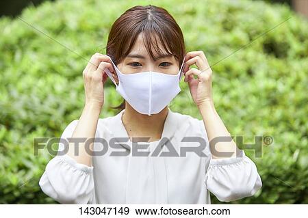 Young Japanese businesswoman wearing mask in the hot Summer downtown Tokyo View Large Photo Image Stock Photo - Young Japanese businesswoman wearing mask in the hot Summer downtown Tokyo. Fotosearch