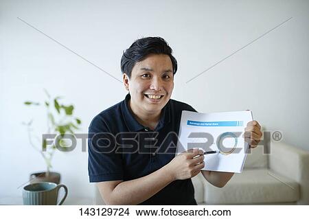 Young Japanese man having a remote video call View Large Photo Image Picture - Young Japanese man having a remote video call. Fotosearch