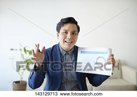 Young Japanese man having a remote video call View Large Photo Image Stock Image - Young Japanese man having a remote video call. Fotosearch