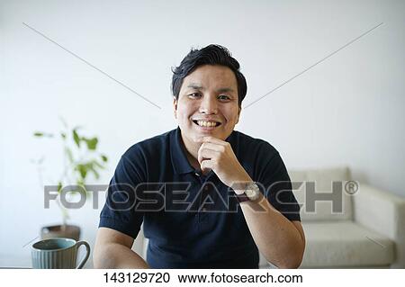 Young Japanese man having a remote video call View Large Photo Image Stock Image - Young Japanese man having a remote video call. Fotosearch