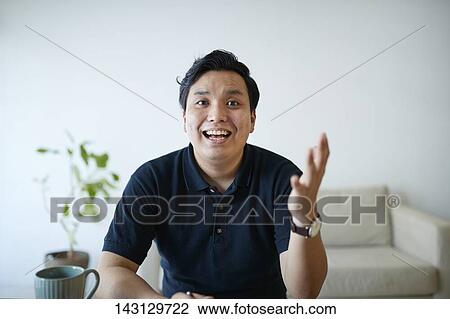 Young Japanese man having a remote video call View Large Photo Image Stock Image - Young Japanese man having a remote video call. Fotosearch
