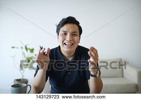 Young Japanese man having a remote video call View Large Photo Image Stock Image - Young Japanese man having a remote video call. Fotosearch