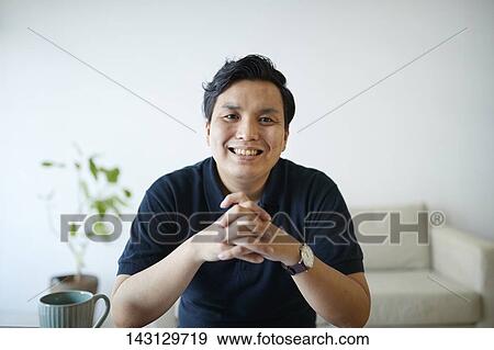 Young Japanese man having a remote video call View Large Photo Image Stock Photo - Young Japanese man having a remote video call. Fotosearch