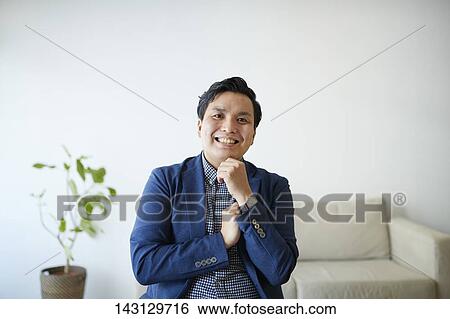 Young Japanese man having a remote video call View Large Photo Image Stock Photograph - Young Japanese man having a remote video call. Fotosearch