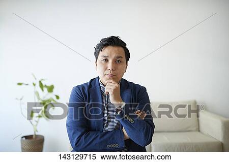 Young Japanese man having a remote video call View Large Photo Image Stock Photography - Young Japanese man having a remote video call. Fotosearch