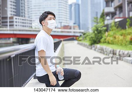 Young Japanese man training downtown Tokyo View Large Photo Image Picture - Young Japanese man training downtown Tokyo. Fotosearch