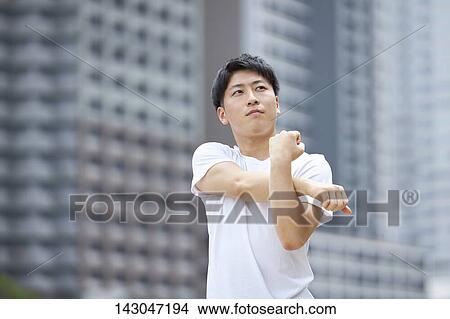 Picture - Young Japanese man training downtown Tokyo. Fotosearch