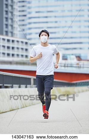 Young Japanese man training downtown Tokyo View Large Photo Image Stock Image - Young Japanese man training downtown Tokyo. Fotosearch