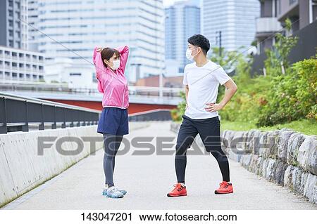 Stock Image - Young Japanese people training downtown Tokyo. Fotosearch