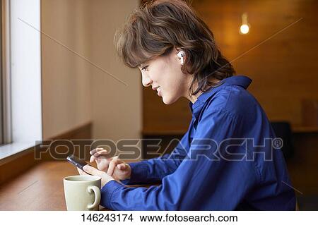 Picture - Young Japanese woman at a cafe. Fotosearch
