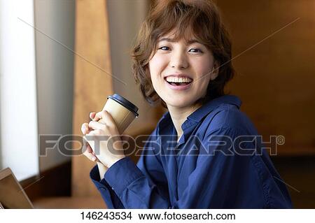 Picture - Young Japanese woman at a cafe. Fotosearch