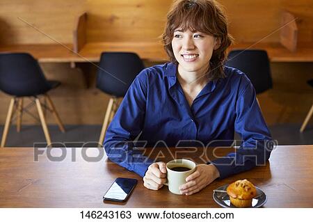 Young Japanese woman at a cafe View Large Photo Image Stock Image - Young Japanese woman at a cafe. Fotosearch