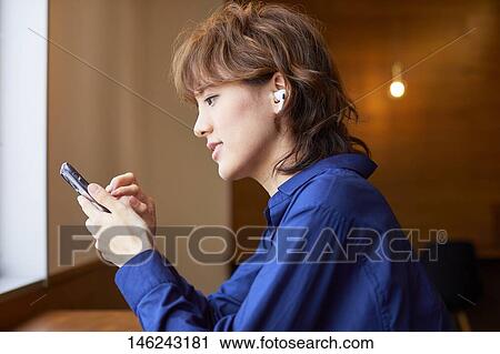 Young Japanese woman at a cafe View Large Photo Image Stock Image - Young Japanese woman at a cafe. Fotosearch