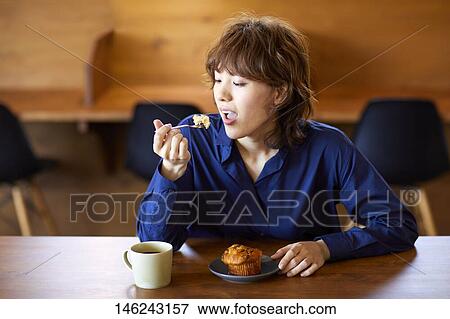 Stock Photo - Young Japanese woman at a cafe. Fotosearch