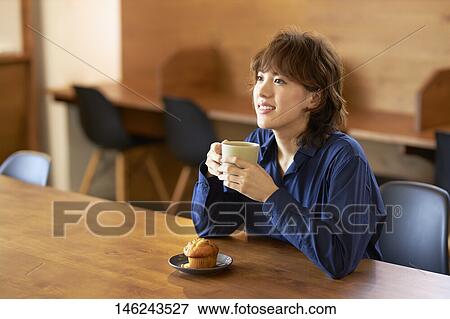 Young Japanese woman at a cafe View Large Photo Image Stock Photo - Young Japanese woman at a cafe. Fotosearch