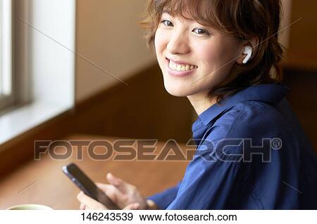 Young Japanese woman at a cafe View Large Photo Image Stock Photo - Young Japanese woman at a cafe. Fotosearch