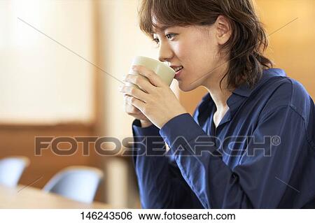 Stock Photograph - Young Japanese woman at a cafe. Fotosearch