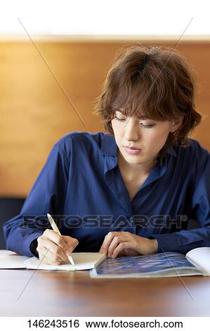 Young Japanese woman at a cafe View Large Photo Image Stock Photograph - Young Japanese woman at a cafe. Fotosearch