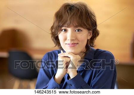 Stock Photography - Young Japanese woman at a cafe. Fotosearch