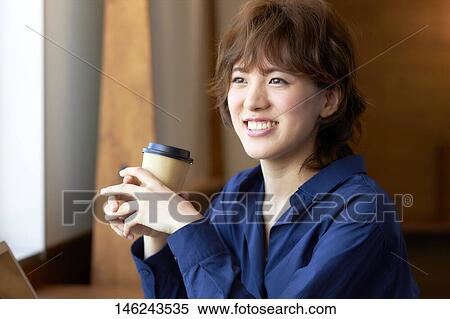 Young Japanese woman at a cafe View Large Photo Image Stock Photography - Young Japanese woman at a cafe. Fotosearch