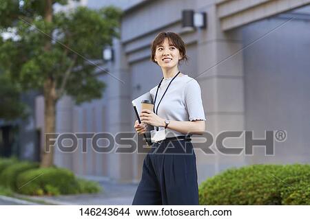 Picture - Young Japanese woman outside. Fotosearch