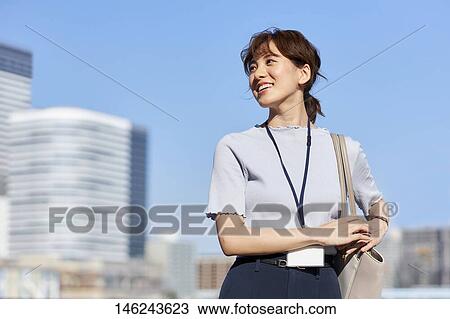 Stock Image - Young Japanese woman outside. Fotosearch