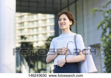 Stock Image - Young Japanese woman outside. Fotosearch