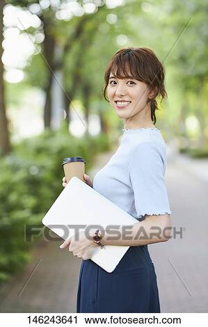Young Japanese woman outside View Large Photo Image Stock Image - Young Japanese woman outside. Fotosearch