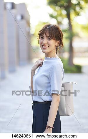 Stock Image - Young Japanese woman outside. Fotosearch