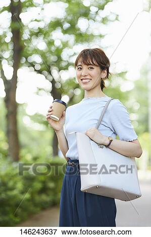Young Japanese woman outside View Large Photo Image Stock Photo - Young Japanese woman outside. Fotosearch