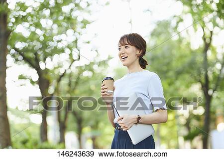 Young Japanese woman outside View Large Photo Image Stock Photo - Young Japanese woman outside. Fotosearch
