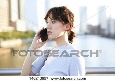 Young Japanese woman outside View Large Photo Image Stock Photo - Young Japanese woman outside. Fotosearch