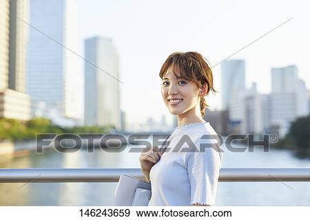 Young Japanese woman outside View Large Photo Image Stock Photo - Young Japanese woman outside. Fotosearch