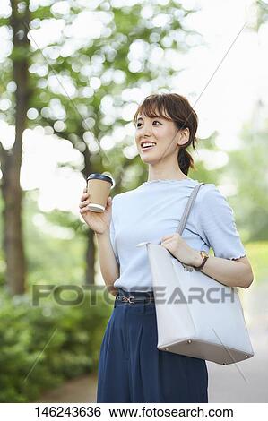 Stock Photograph - Young Japanese woman outside. Fotosearch