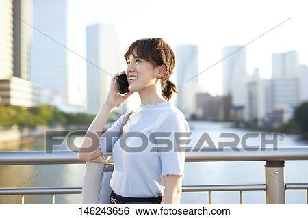 Young Japanese woman outside View Large Photo Image Stock Photograph - Young Japanese woman outside. Fotosearch
