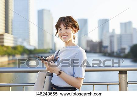 Stock Photography - Young Japanese woman outside. Fotosearch
