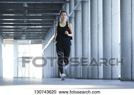 Young Japanese Woman Running Downtown Tokyo, Japan View Large Photo Image Stock Image - Young Japanese Woman Running Downtown Tokyo, Japan. Fotosearch