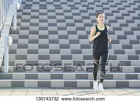 Young Japanese Woman Running Downtown Tokyo, Japan View Large Photo Image Stock Image - Young Japanese Woman Running Downtown Tokyo, Japan. Fotosearch