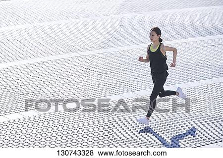 Young Japanese Woman Running Downtown Tokyo, Japan View Large Photo Image Stock Photo - Young Japanese Woman Running Downtown Tokyo, Japan. Fotosearch