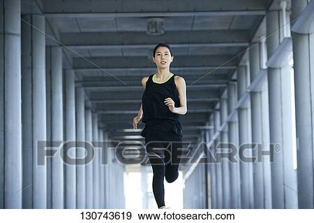 Young Japanese Woman Running Downtown Tokyo, Japan View Large Photo Image Stock Photo - Young Japanese Woman Running Downtown Tokyo, Japan. Fotosearch